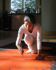 Mayumi Oda painting on the floor
