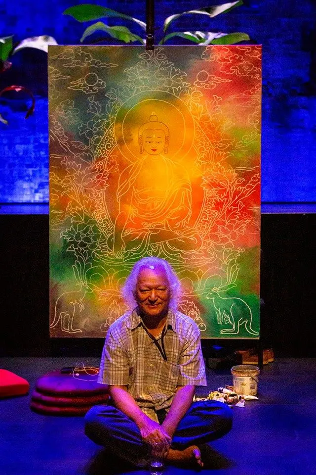 Karma Phuntsok sitting in front of his painting